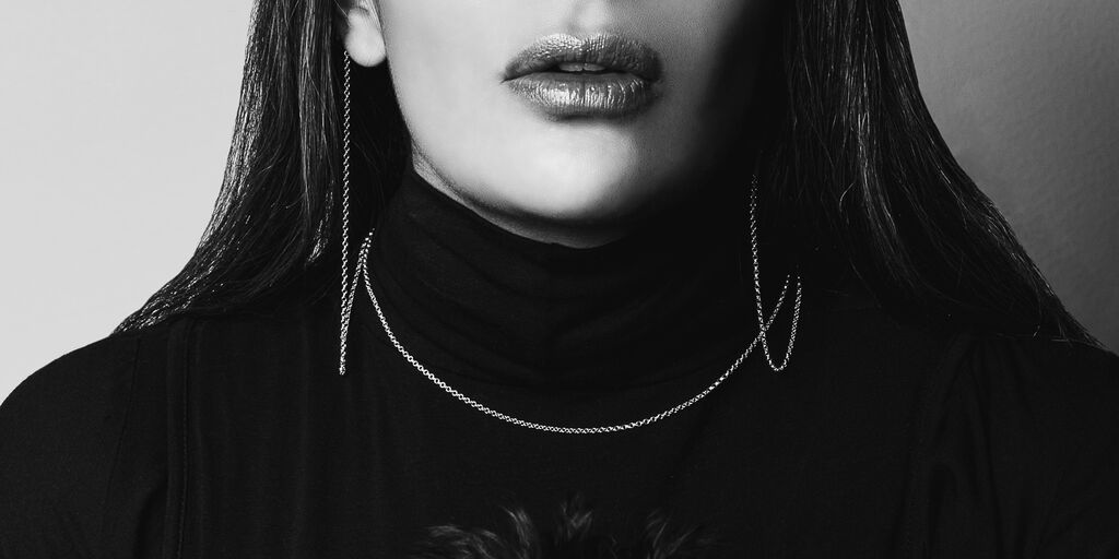Black and white image shows safety necklace in silver